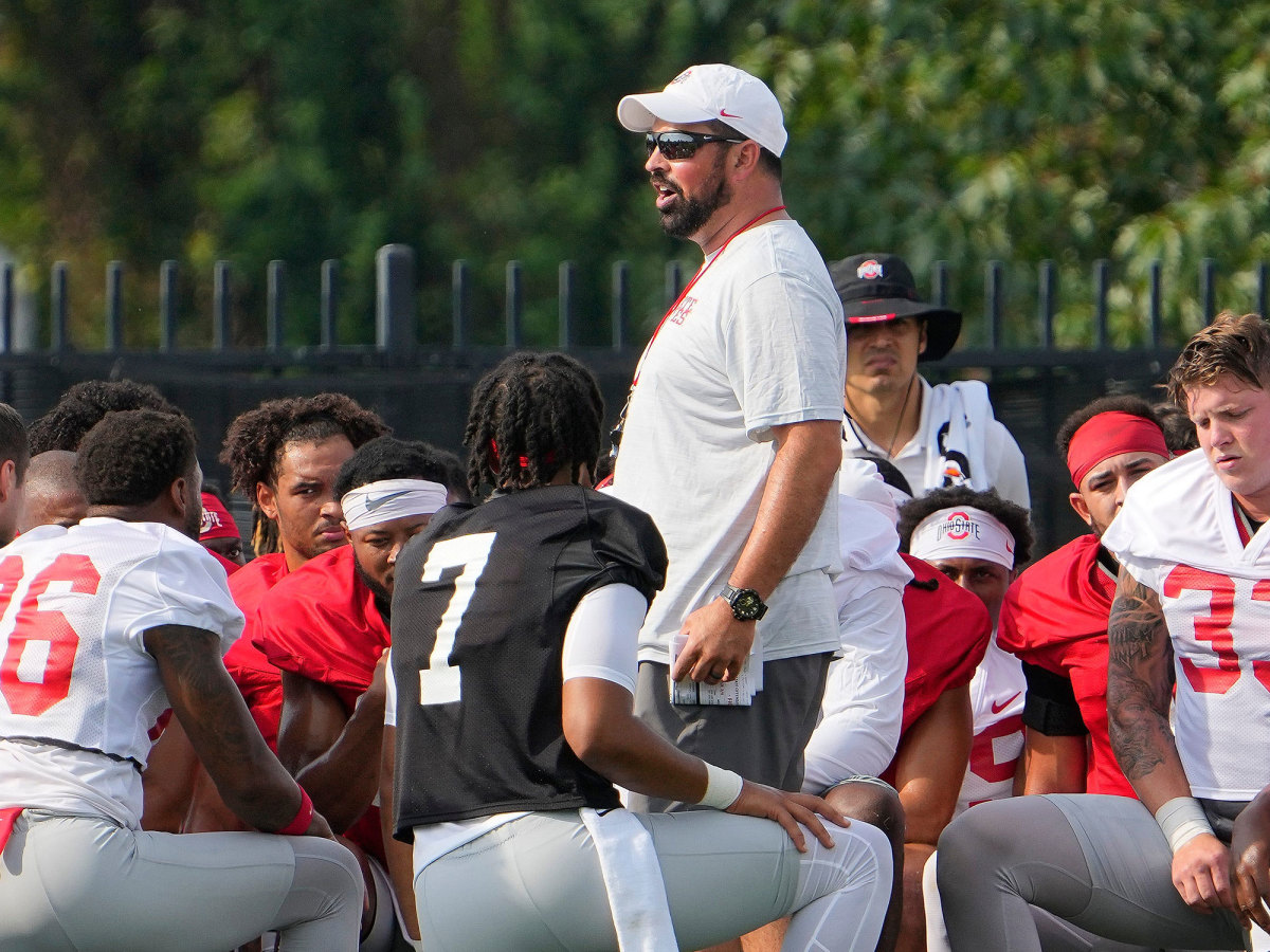 Ohio State coach Ryan Day talks to his team at camp