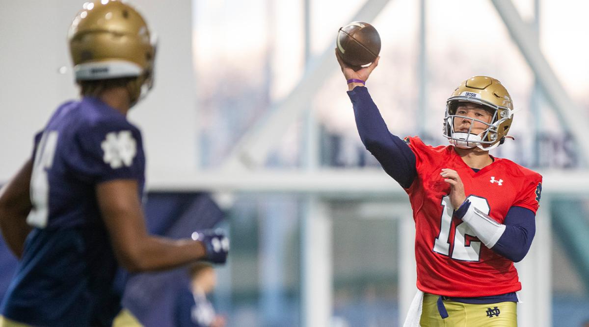 March 17, 2022; South Bend, IN, USA; Notre Dame’s Tyler Buchner, right, throws during a Notre Dame football spring practice.