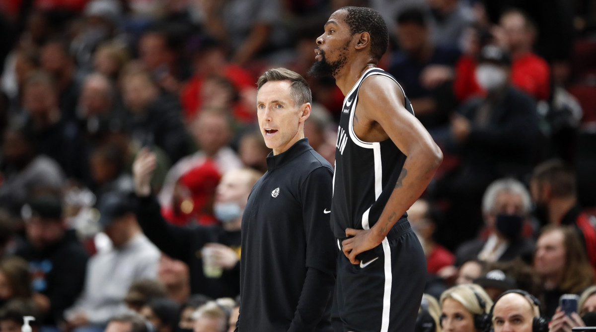 Steve Nash talks with forward Kevin Durant during the first half of an NBA game against the Chicago Bulls.