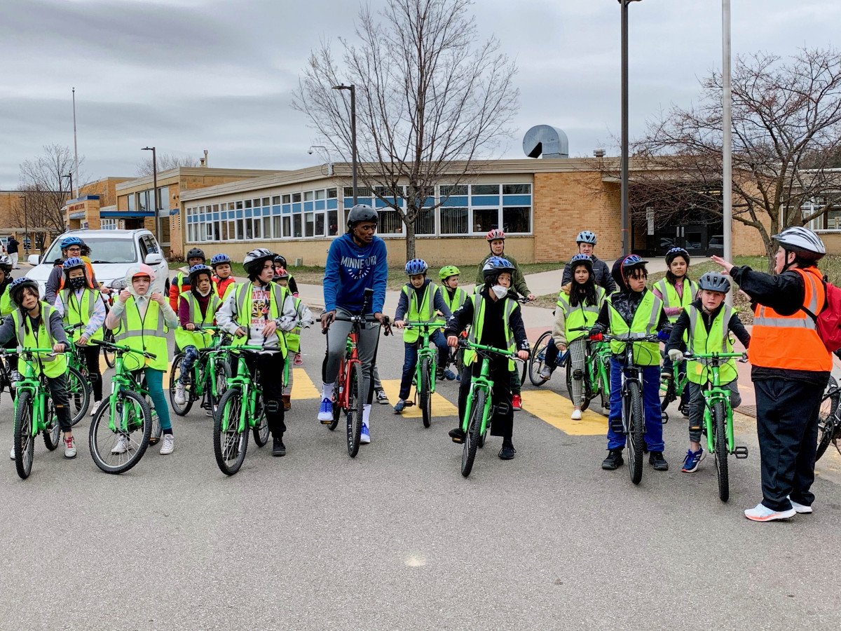 Minnesota Lynx star Sylvia Fowles rides her bike alongside students from Minneapolis’ Bryn Mawr Elementary School.