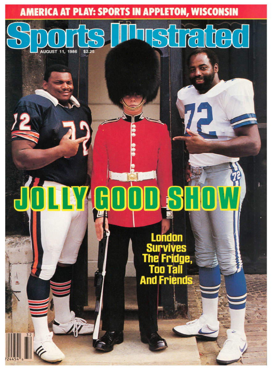 NFL players pose with a Buckingham Palace guard