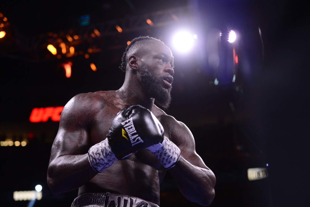 Deontay Wilder (red/black trunks) and Tyson Fury (black/gold trunks) box during their WBC/Lineal heavyweight championship boxing match at T-Mobile Arena.