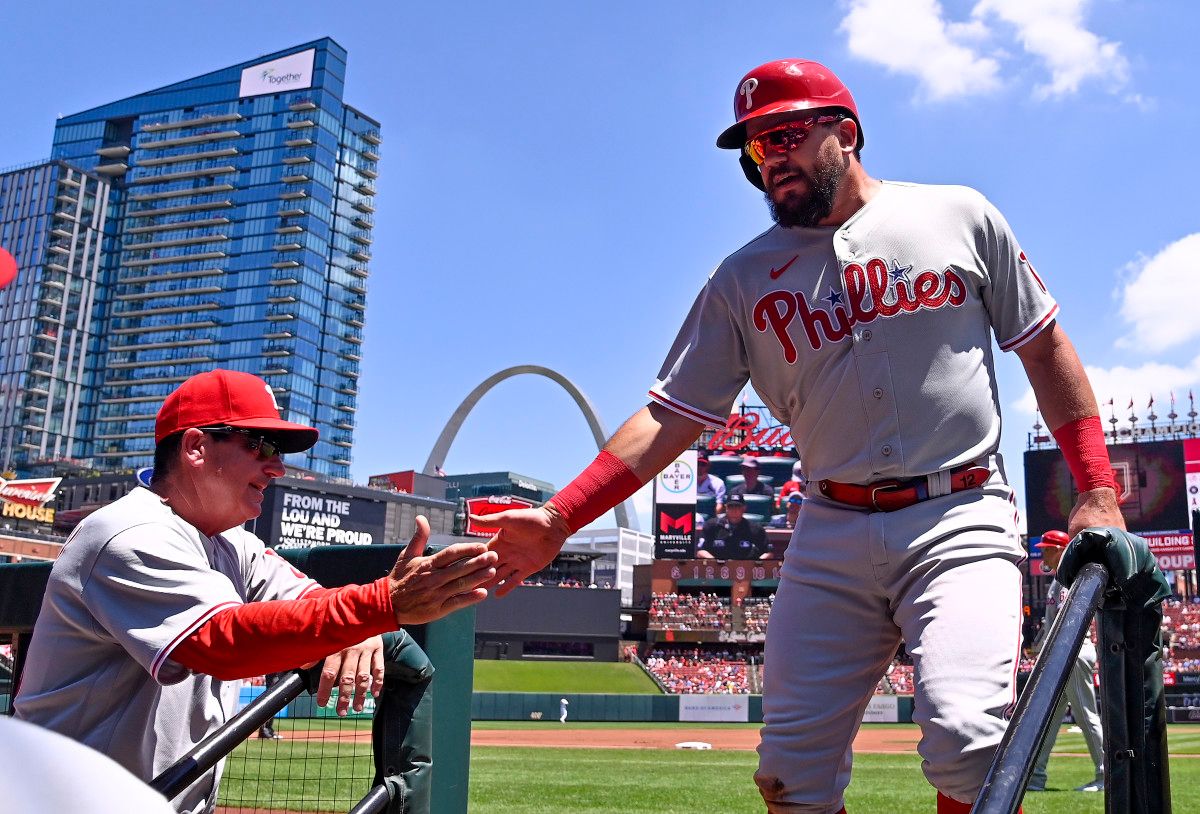 Kyle Schwarber celebrates with interim manager Rob Thomson.