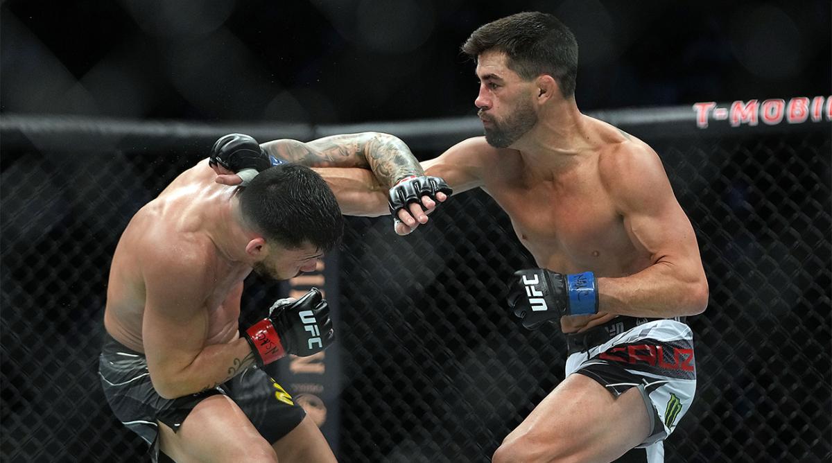 Dec 11, 2021; Las Vegas, Nevada, USA; Dominick Cruz lands a punch against Pedro Munhoz during UFC 269 at T-Mobile Arena.