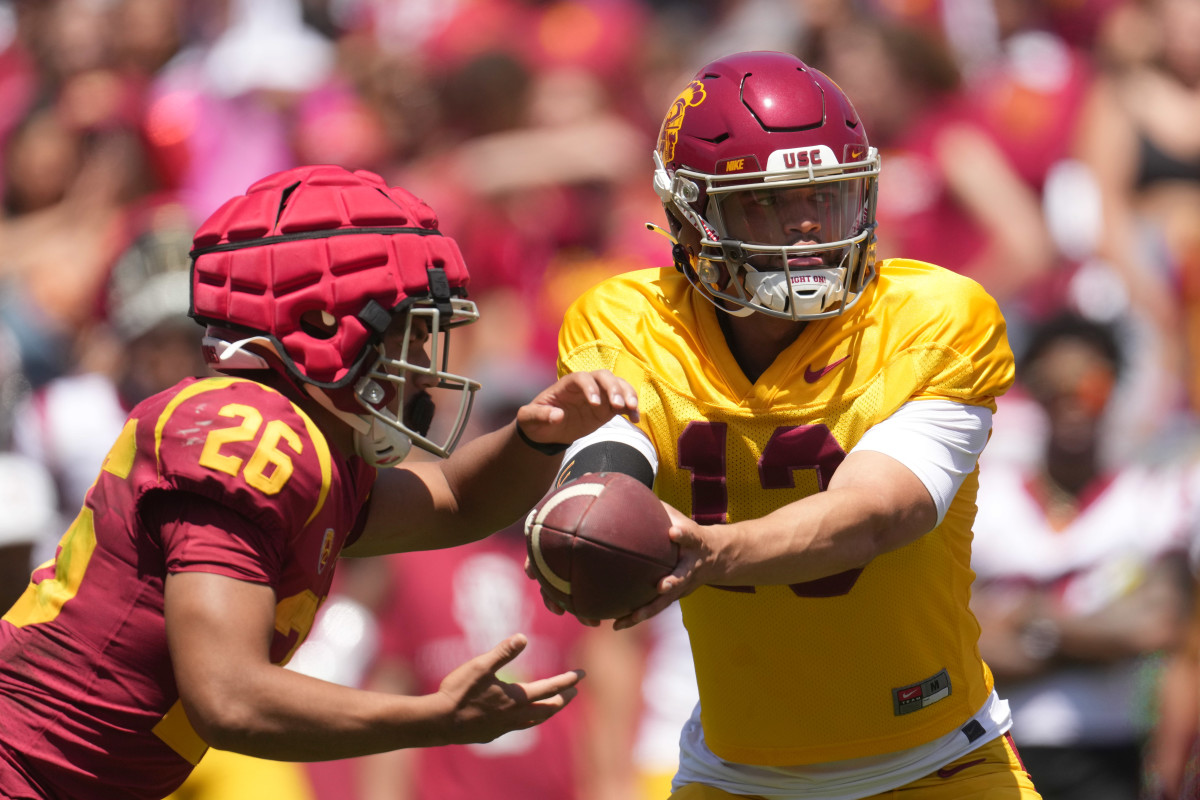 Southern California Trojans quarterback Caleb Williams (13) hands off the ball to running back Travis Dye (26) during the spring game at the Los Angeles Memorial Coliseum.