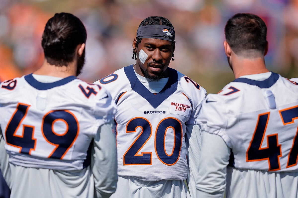 Denver Broncos safety J.R. Reed (20) talks with inside linebacker Alex Singleton (49) and inside linebacker Josey Jewell (47) during training camp at the UCHealth Training Center.