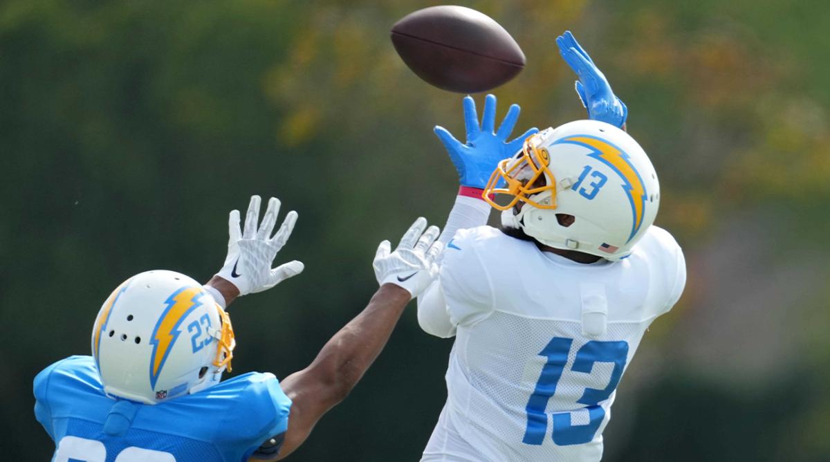 Aug 1, 2022; Costa Mesa, CA, USA; Los Angeles Chargers receiver Keenan Allen (13) catches the ball as safety JT Woods (22) defends during training camp at the Jack Hammett Sports Complex.