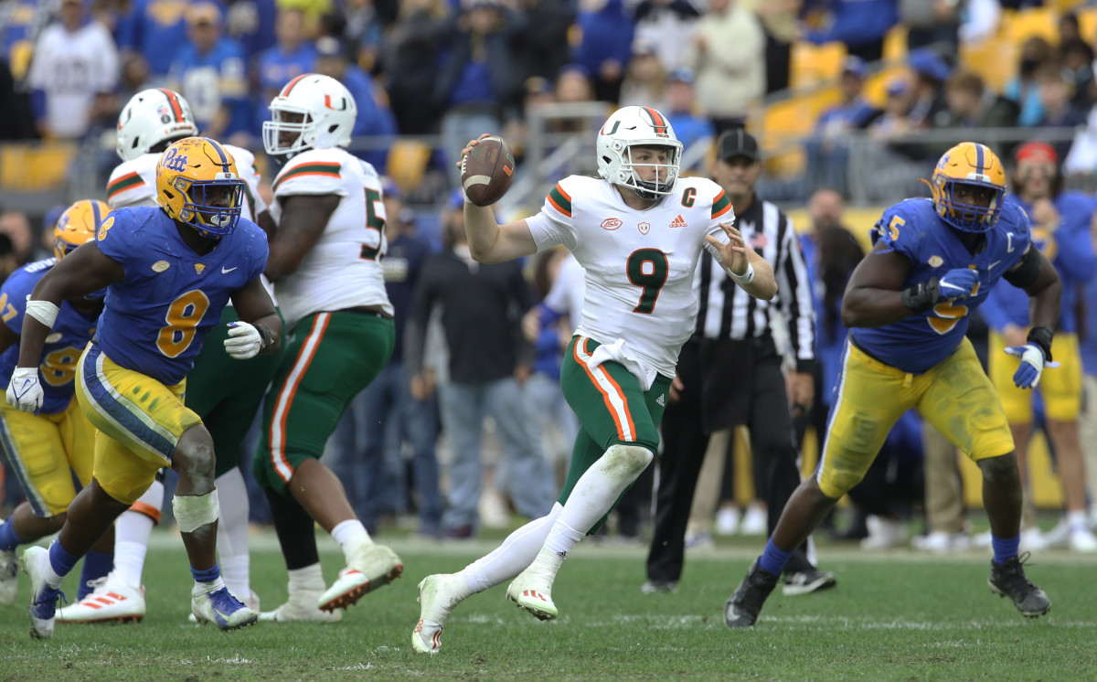 Miami Hurricanes quarterback Tyler Van Dyke (9) scrambles with the ball as Pittsburgh Panthers defensive lineman Calijah Kancey (8) and defensive lineman Deslin Alexandre (5) chase during the fourth quarter at Heinz Field. Miami won 38-34.