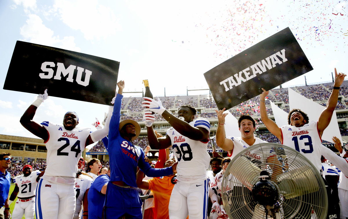 Southern Methodist Mustangs defensive end Toby Ndukwe (38) pops a champagne bottle to release confetti after a turnover during the first half against the TCU Horned Frogs at Amon G. Carter Stadium.
