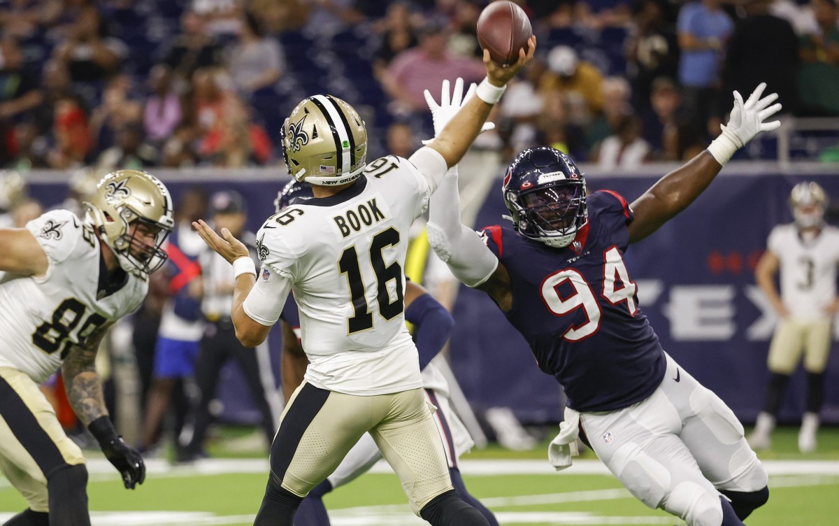 New Orleans Saints quarterback Ian Book (16) attempts a pass as Houston Texans defensive lineman Demone Harris (94) applies pressure. Mandatory Credit: Troy Taormina-USA TODAY