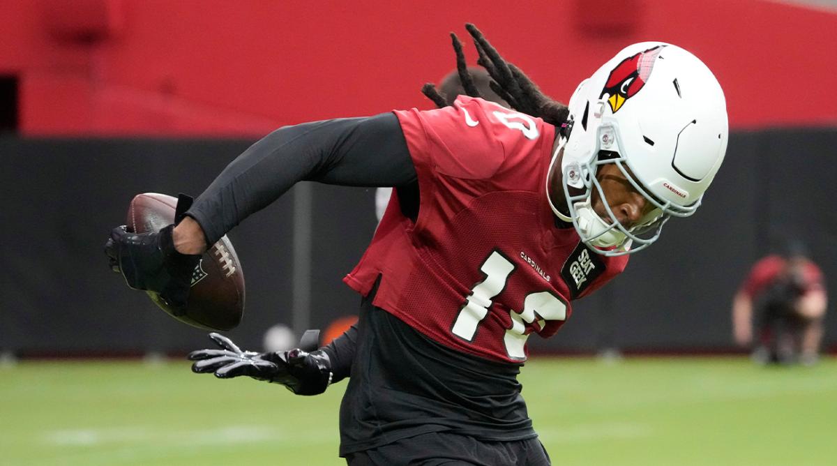 Arizona Cardinals DeAndre Hopkins (10) catches a pass behind his back during training camp at State Farm Stadium in Glendale on July 27, 2022.