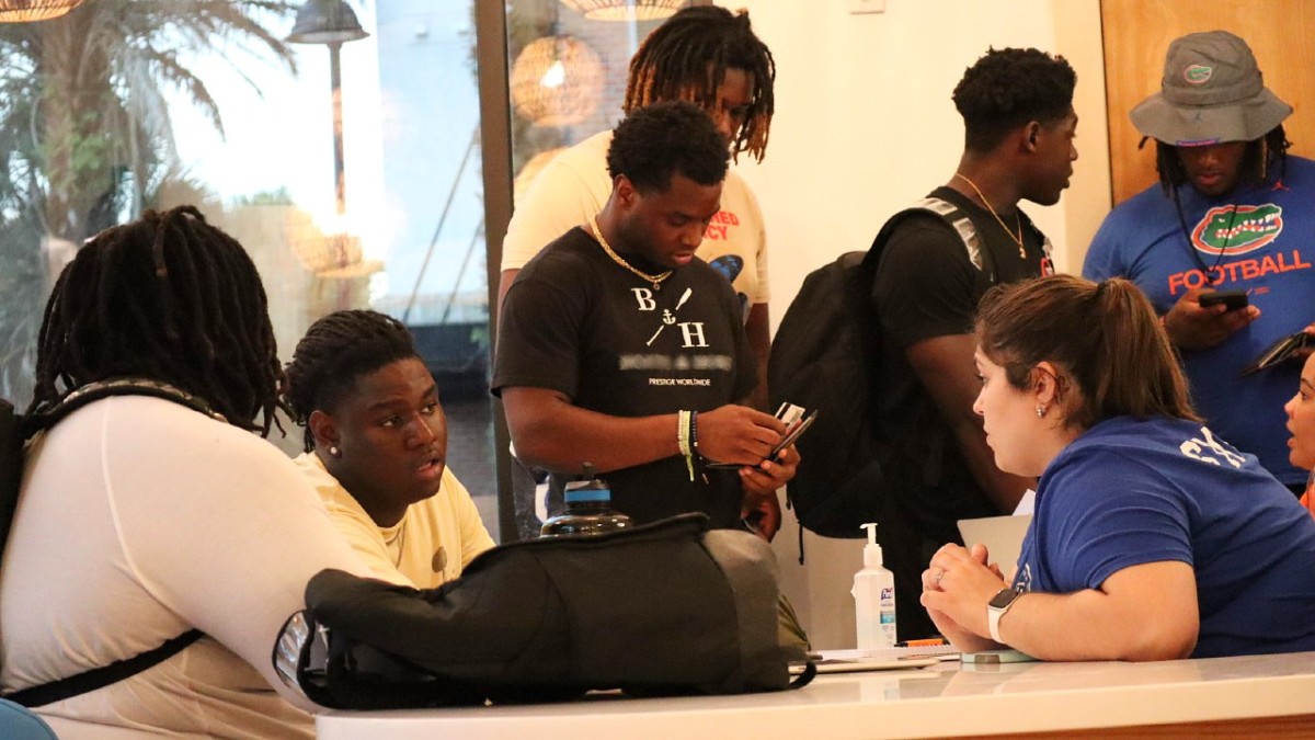 Several Florida Gators meet with Stadium House representatives to receive the keys to their new apartments on Sunday.