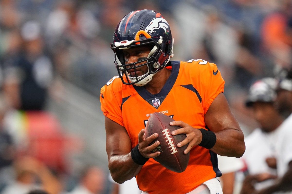 Denver Broncos quarterback Russell Wilson (3) warms up before the preseason game against the Dallas Cowboys at Empower Field at Mile High.