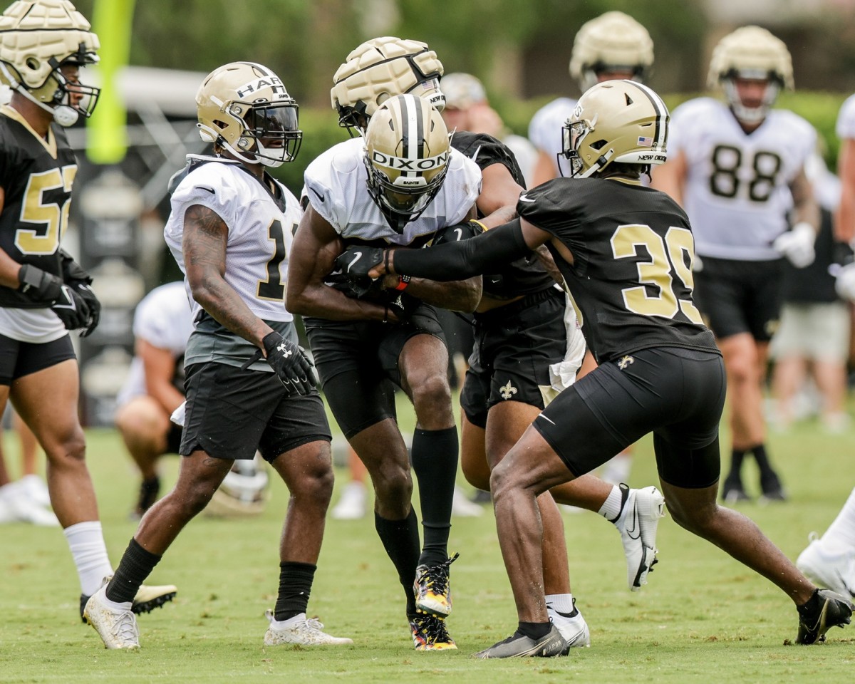 New Orleans Saints receiver Dai'Jean Dixon (84) runs though defensive back DaMarcus Fields (39) during training camp. Mandatory Credit: Stephen Lew-USA TODAY Sports
