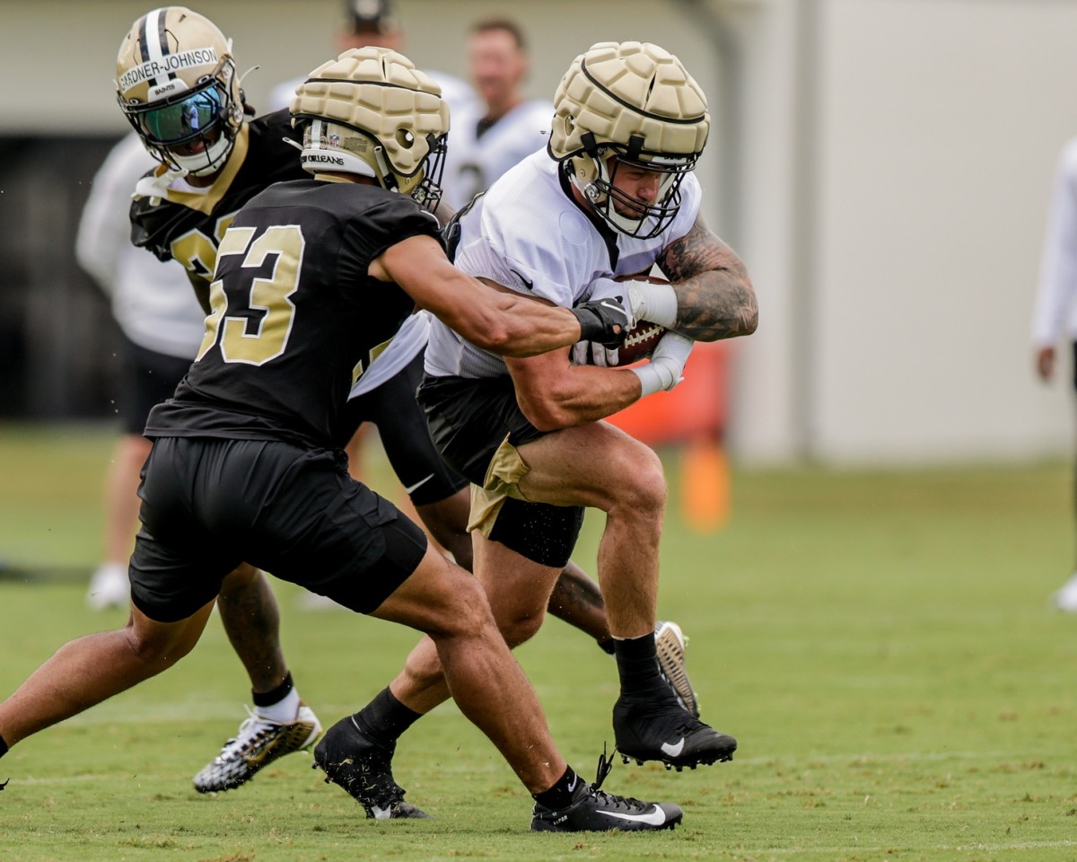 Jul 29, 2022; New Orleans Saints linebacker Zack Baun (53) tries to punch the ball loose from fullback Adam Prentice (46) during training camp. Mandatory Credit: Stephen Lew-USA TODAY Sports