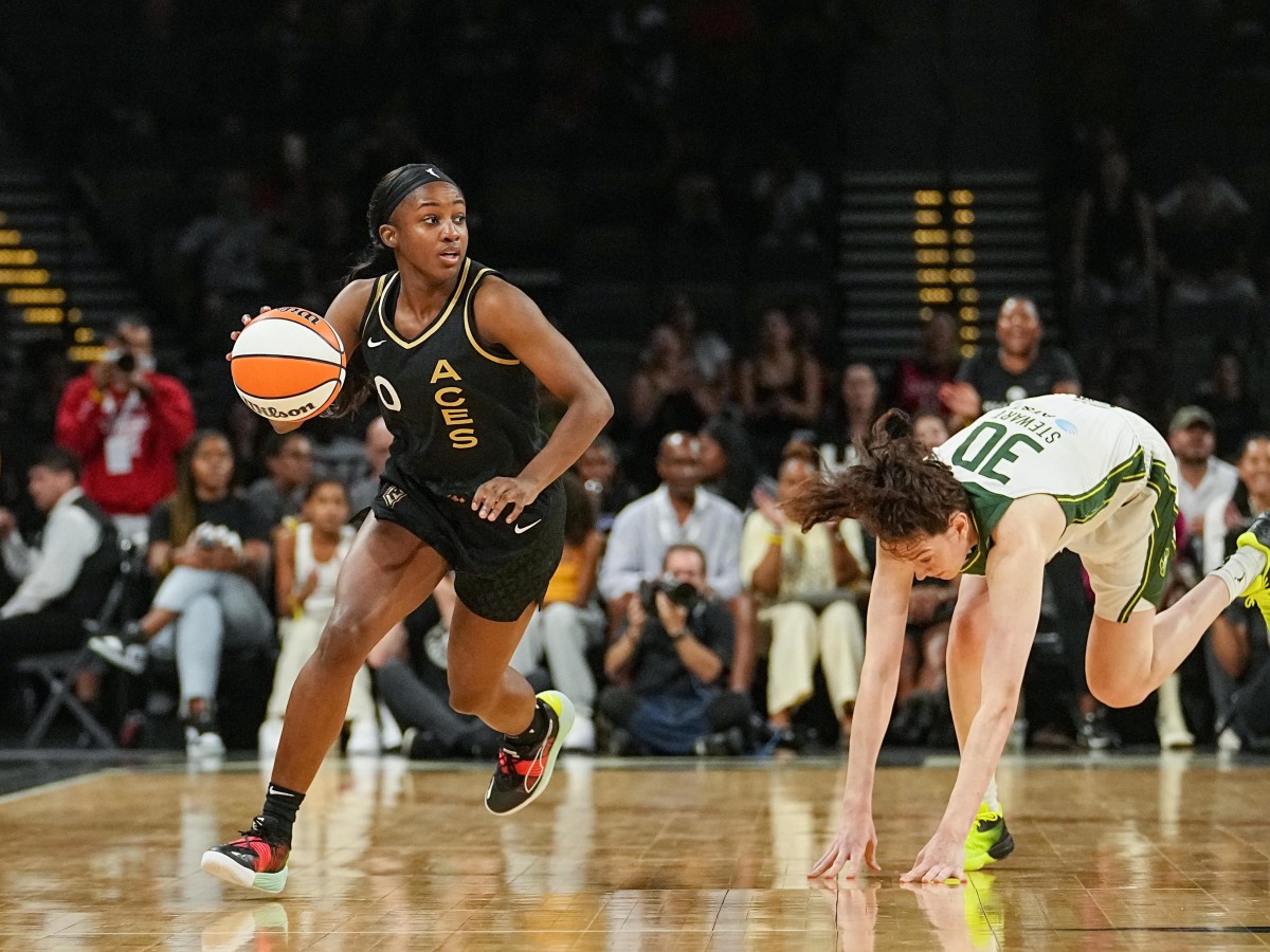 Las Vegas Aces guard Jackie Young maneuvers around Seattle Storm star Breanna Stewart.