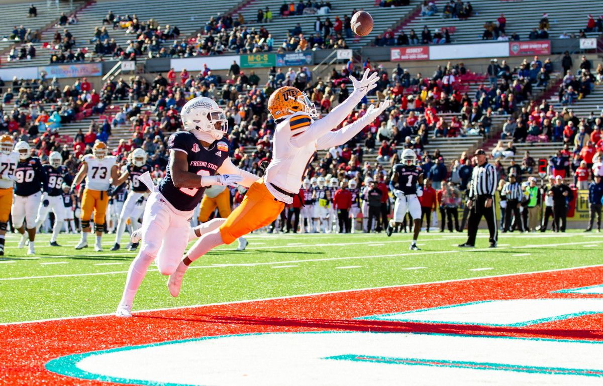 UTEP Miners wide receiver Jacob Cowing (6) stretches out to catch a pass against the Fresno State Bulldogs defense in the first half at the 2021 New Mexico Bowl at Dreamstyle Stadium. Pass interference was called on Bulldogs defensive back Elijah Gates (2) who was covering Cowing.