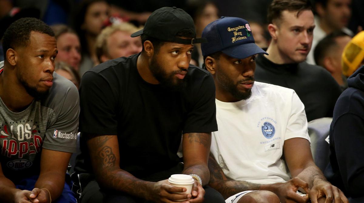 Mar 6, 2022; Los Angeles, California, USA; Los Angeles Clippers guard Paul George and forward Kawhi Leonard watch a game against the New York Knicks during the first half at Crypto.com Arena. The Knicks won 116-93.
