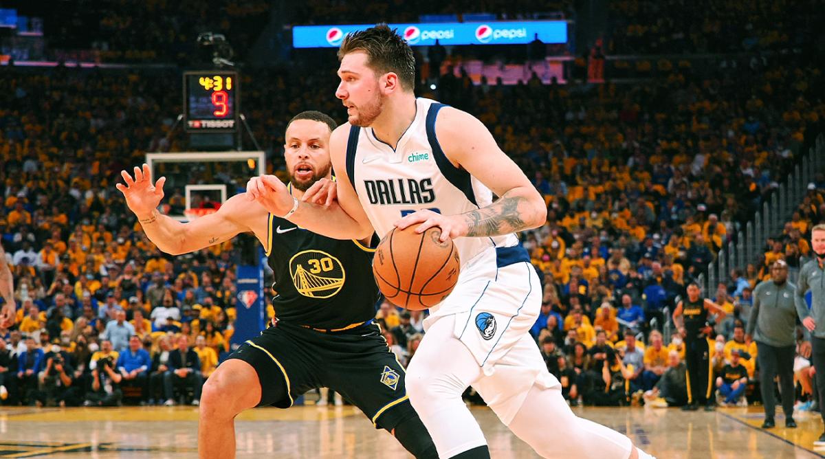May 26, 2022; San Francisco, California, USA; Dallas Mavericks guard Luka Doncic (77) dribbles the ball against Golden State Warriors guard Stephen Curry (30) during the second half of game five of the 2022 western conference finals at Chase Center.