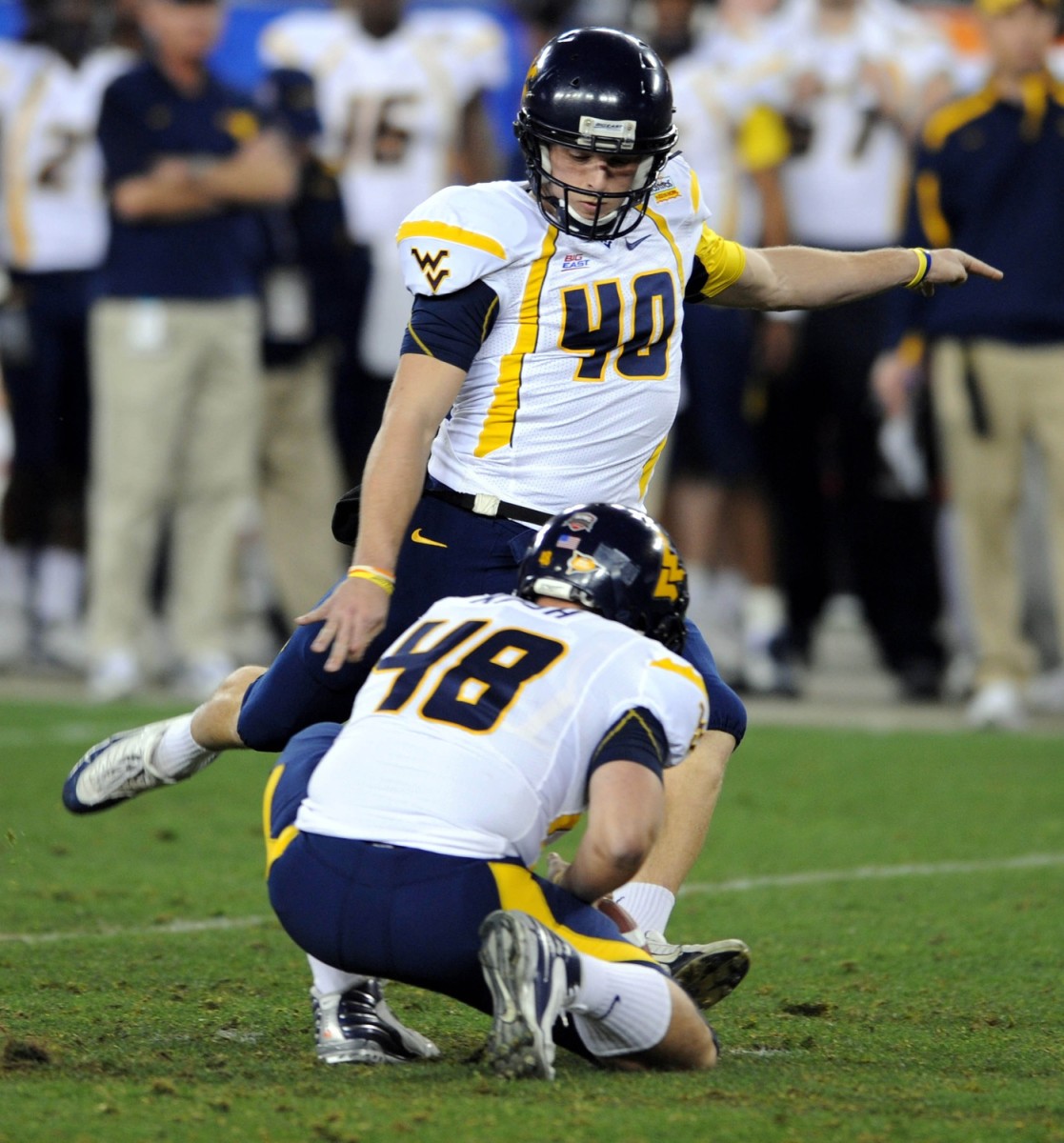 Jan 2, 2008; Glendale, AZ; USA; West Virginia Mountaineers kicker Pat McAfee (40) attempts a field goal out of the hold of Jeremy Kash (48) in the first half against the Oklahoma Sooners in the Fiesta Bowl at University of Phoenix Stadium.