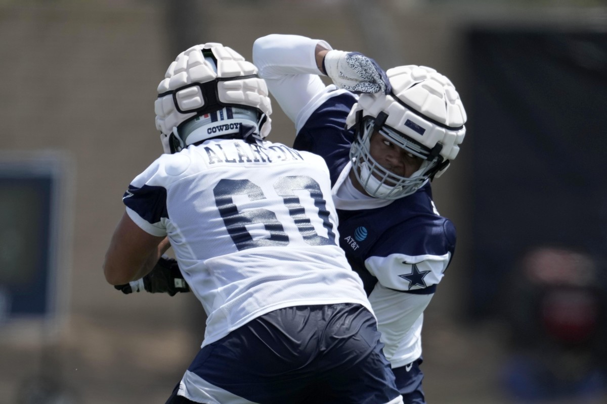 Jul 27, 2022; Oxnard, CA, USA; Dallas Cowboys defensive end Sam Williams (54) tries to get past guard Isaac Alarcon (60) during training camp at the River Ridge Fields. Mandatory Credit: Kirby Lee-USA TODAY Sports
