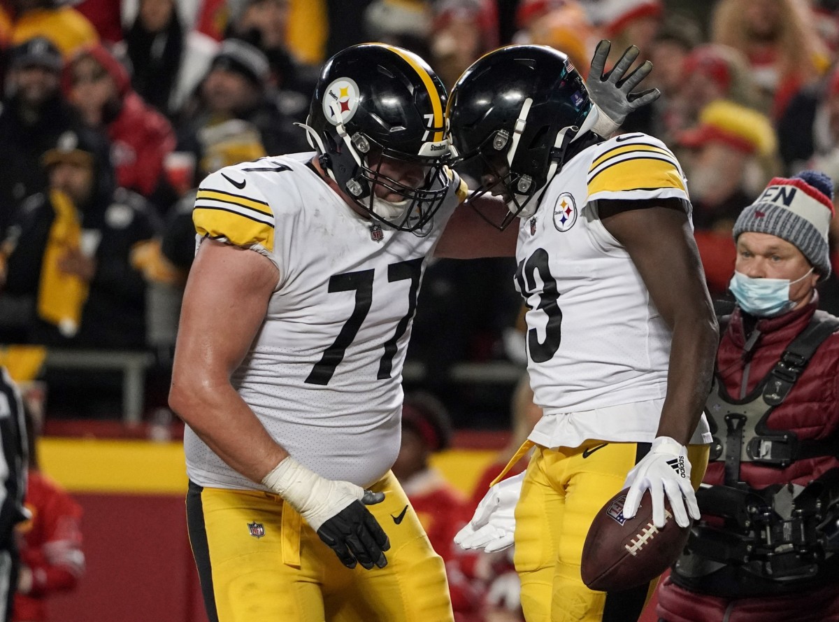 Jan 16, 2022; Kansas City, Missouri, USA; Pittsburgh Steelers guard John Leglue (77) celebrates with wide receiver James Washington (13) after a score against the Kansas City Chiefs in an AFC Wild Card playoff football game at GEHA Field at Arrowhead Stadium. Mandatory Credit: Denny Medley-USA TODAY Sports