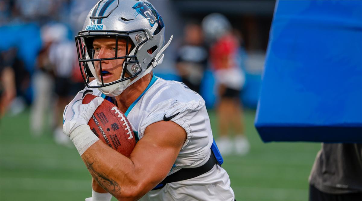 Carolina Panthers running back Christian McCaffrey carries the football during a drill at the NFL football team’s Fan Fest in Charlotte, N.C., Thursday, Aug. 11, 2022.