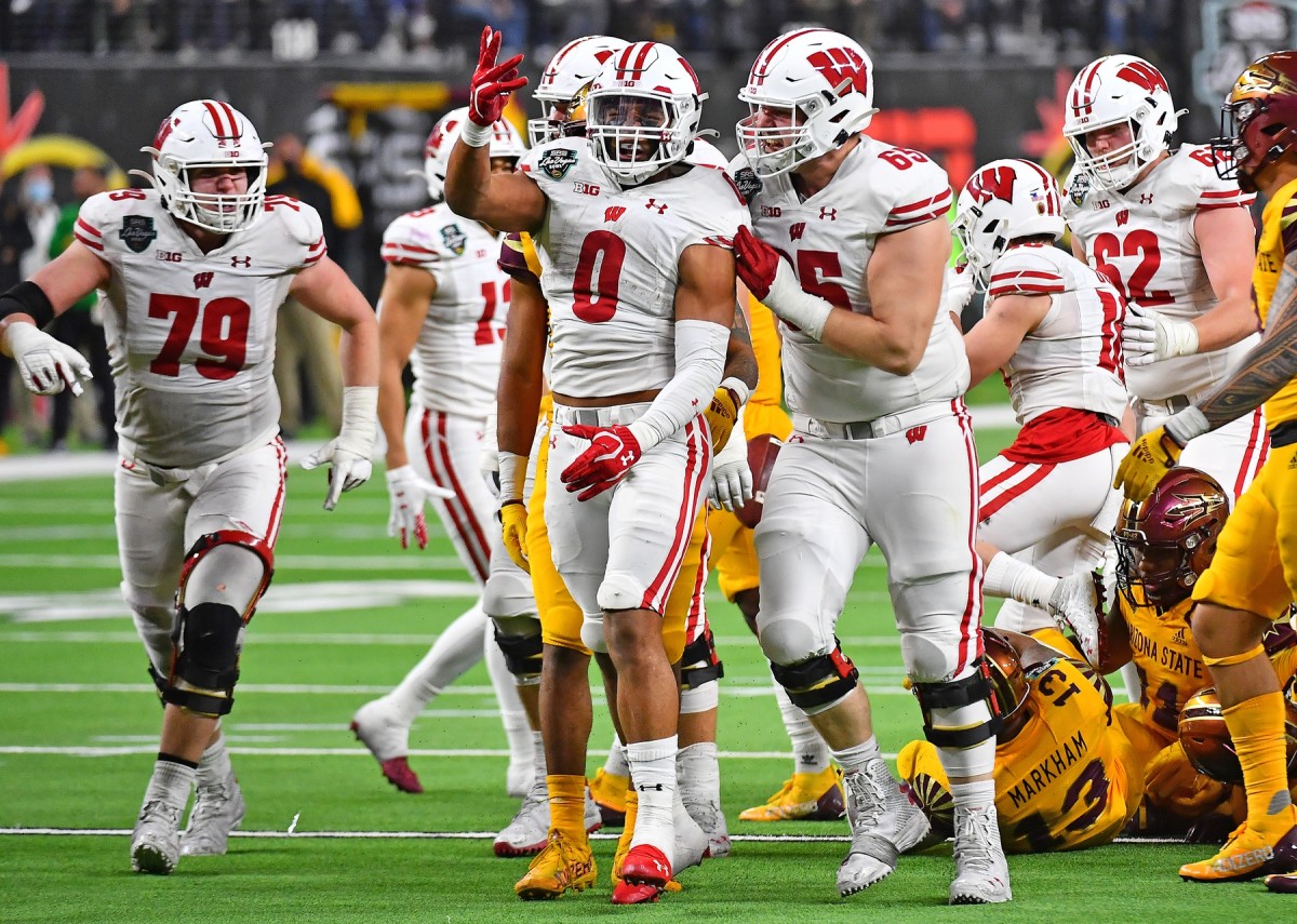 Dec 30, 2021; Paradise, Nevada, USA; Wisconsin Badgers running back Braelon Allen (0) celebrates after gaining a first down against the Arizona State Sun Devils late in the fourth quarter during the 2021 Las Vegas Bowl at Allegiant Stadium. Mandatory Credit: Stephen R. Sylvanie-USA TODAY Sports