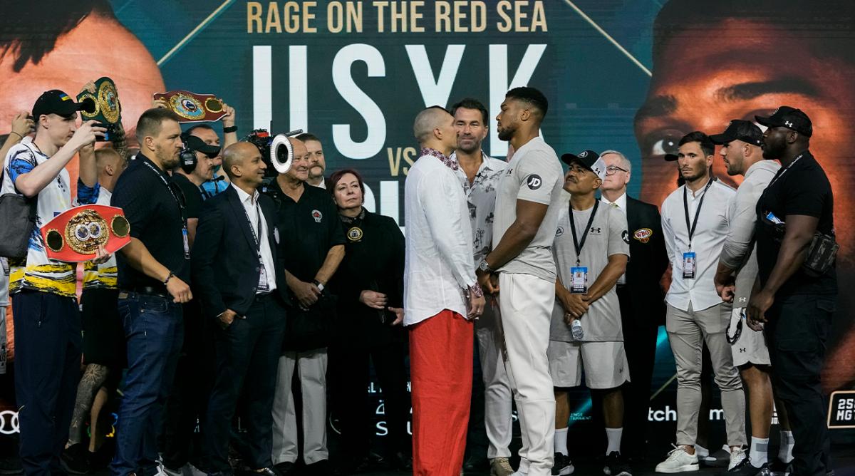 Heavyweight boxers Britain’s Anthony Joshua, center right, and Ukraine’s Oleksandr Usyk, center left, face off during a weigh-in at King Abdullah Sports City in Jeddah, Saudi Arabia, Friday, Aug. 19, 2022. Joshua is due to fight defending champion Usyk in a heavyweight boxing rematch in Jeddah on Aug. 20.
