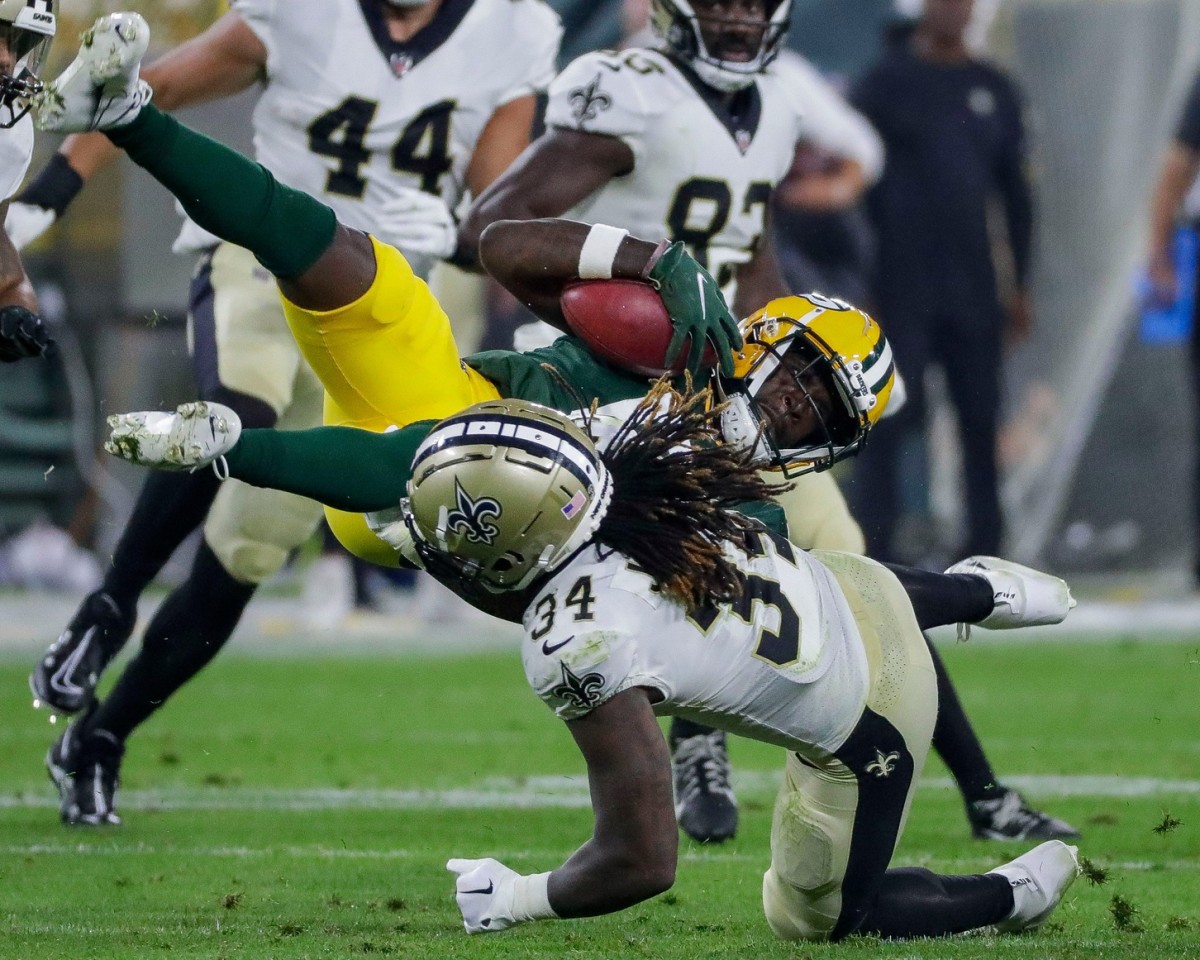 Green Bay Packers receiver Amari Rodgers is upended by New Orleans Saints running back Tony Jones Jr. (34) on a punt return. Tork Mason / USA TODAY NETWORK
