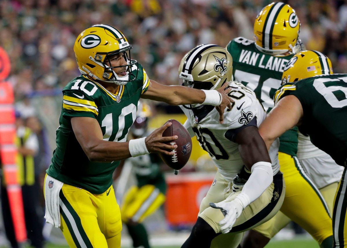 Packers quarterback Jordan Love (10) scrambles in the pocket as Saints defensive end Tanoh Kpassagnon (90) closes in. Tork Mason / USA TODAY NETWORK