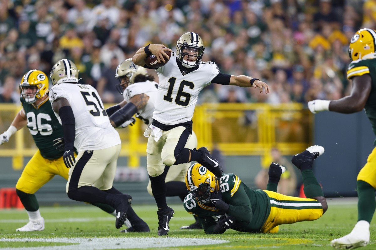 New Orleans Saints quarterback Ian Book (16) is tripped up by Green Bay Packers defensive lineman T.J. Slaton (93). Mandatory Credit: Jeff Hanisch-USA TODAY Sports