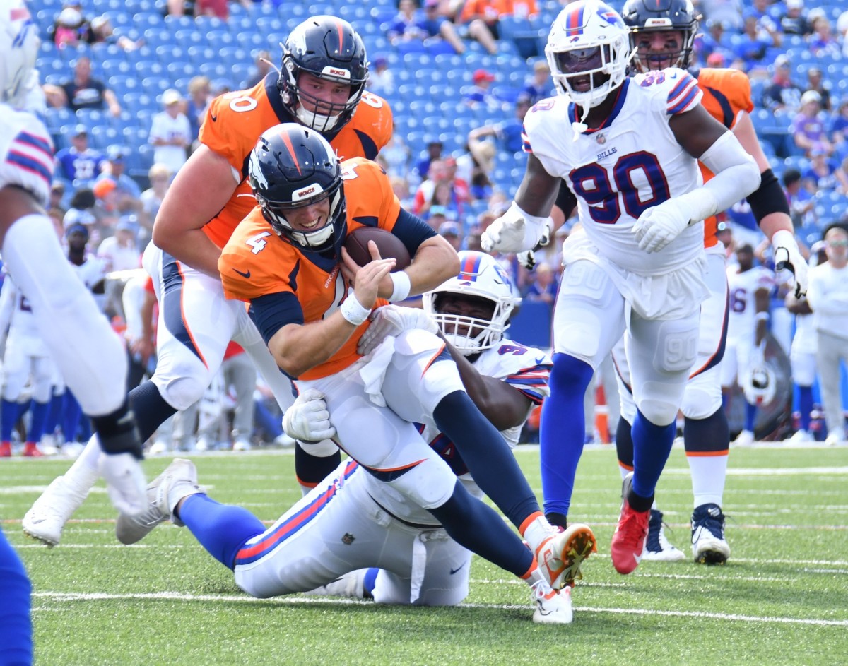 Denver Broncos quarterback Brett Rypien (4) is tackled by Buffalo Bills defensive tackle Prince Emili (94) in the fourth quarter of a pre-season game at Highmark Stadium.