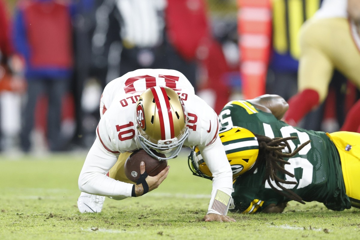 Jan 22, 2022; Green Bay, Wisconsin, USA; San Francisco 49ers quarterback Jimmy Garoppolo (10) is sacked by Green Bay Packers outside linebacker Za'Darius Smith (55) in the first quarter during a NFC Divisional playoff football game at Lambeau Field. Mandatory Credit: Jeff Hanisch-USA TODAY Sports