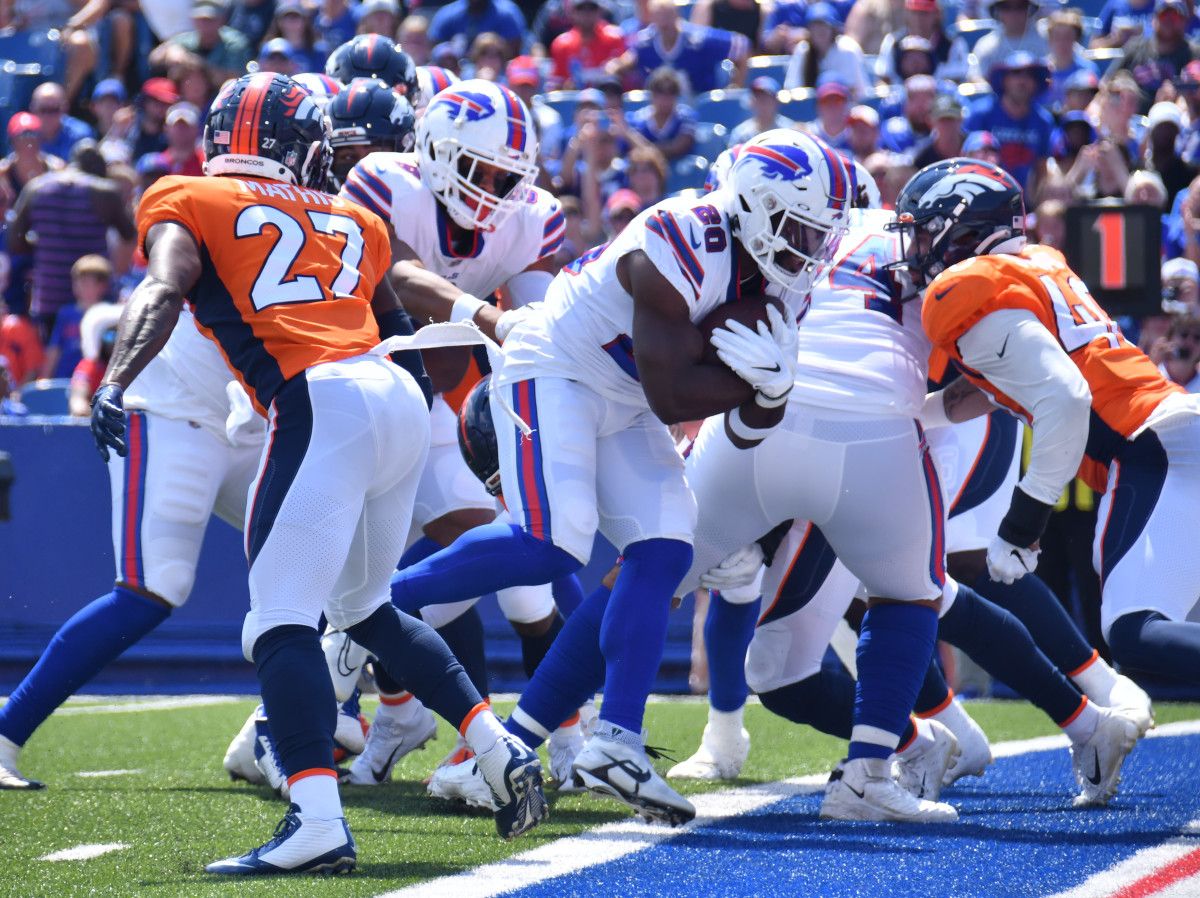 Buffalo Bills running back Zack Moss (20) scores a touchdown in the second quarter of a pre-season game against the Denver Broncos at Highmark Stadium.