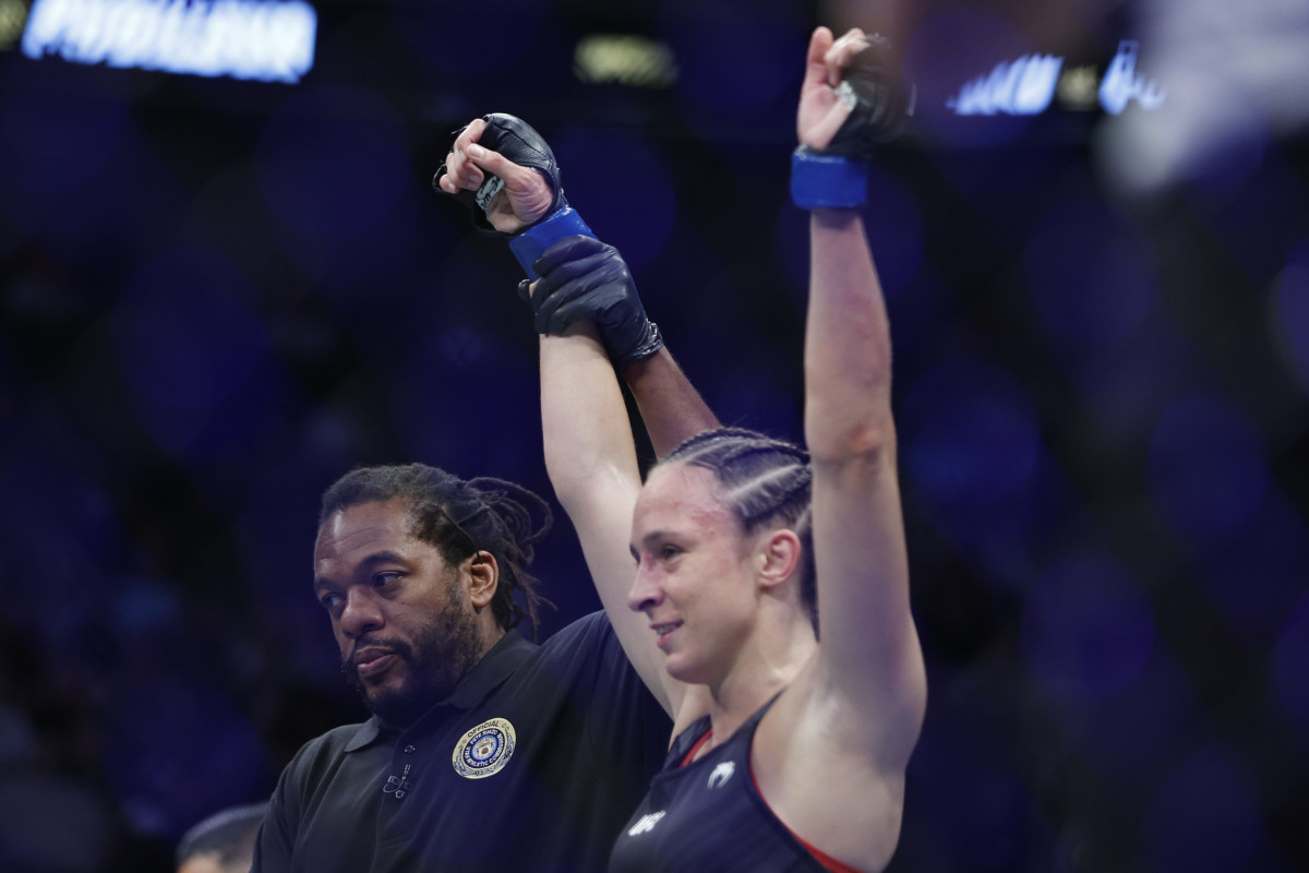 Lucie Pudilova (blue gloves) celebrates defeating Wu Yanan (red gloves) during UFC 278 at Vivint Arena.