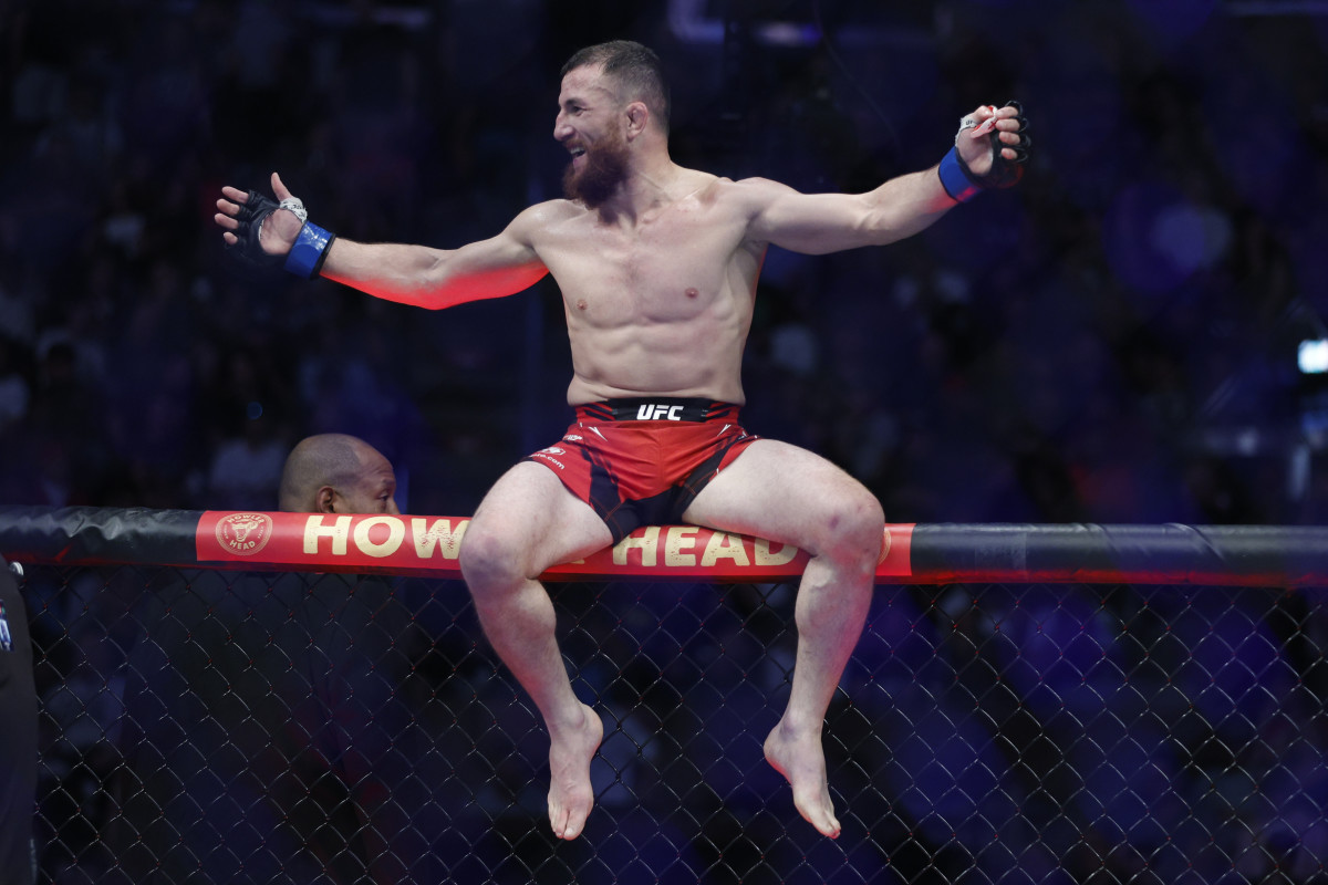 Merab Dvalishvili (blue gloves) reacts after defeating Jose Aldo (red gloves) during UFC 278 at Vivint Arena.