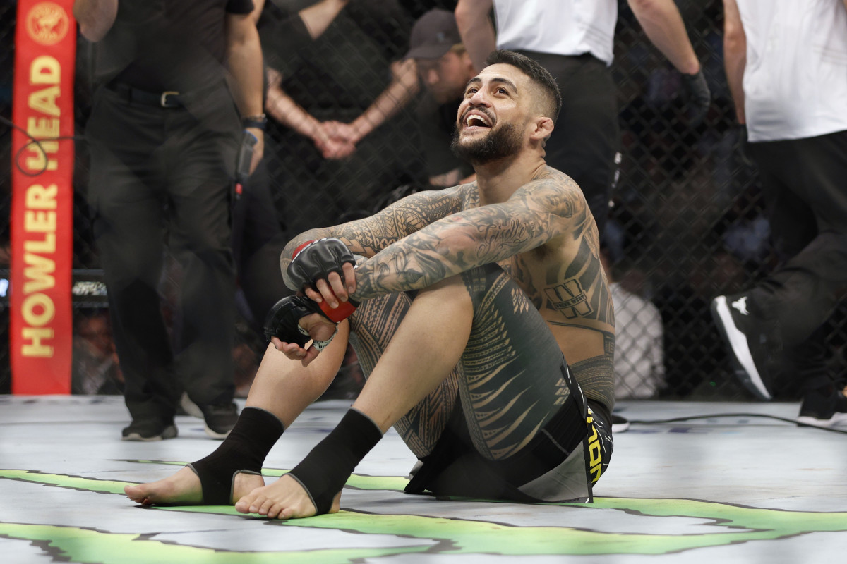 Tyson Pedro (red gloves) reacts after defeating Harry Hunsucker (blue gloves) during UFC 278 at Vivint Arena.