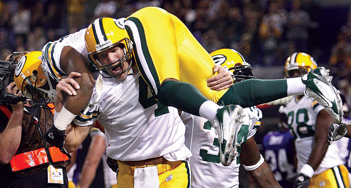 NFL Hall of Fame quarterback Brett Favre picks up one of his teammates in celebration following a win in Green Bay.