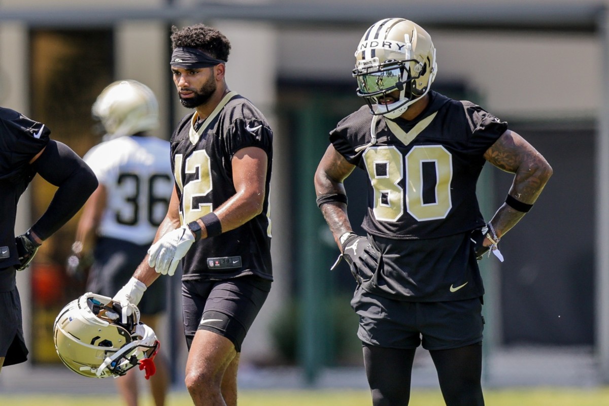 New Orleans Saints Chris Olave (12) and Jarvis Landry (80) look on during organized team activities at the Saints Training Facility. Mandatory Credit: Stephen Lew-USA TODAY