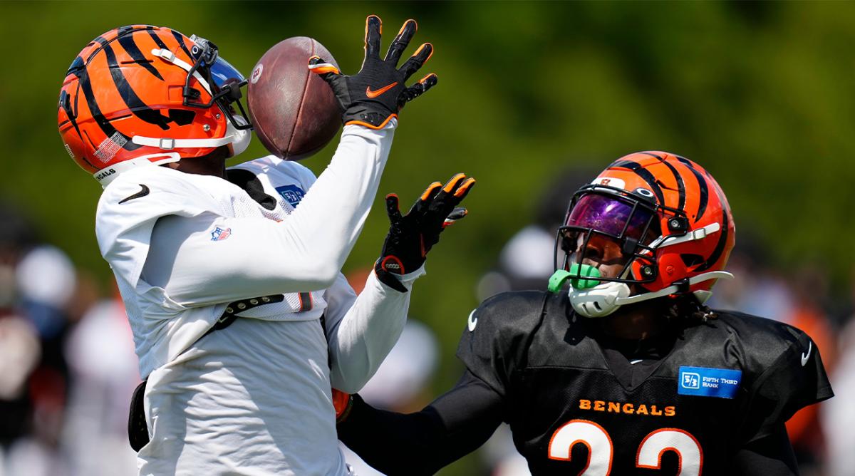 Cincinnati Bengals wide receiver Ja’Marr Chase (1) catches a deep pass over cornerback Chidobe Awuzie (22) during a training camp practice at the Paycor Stadium practice fields in downtown Cincinnati on Wednesday, Aug. 17, 2022.