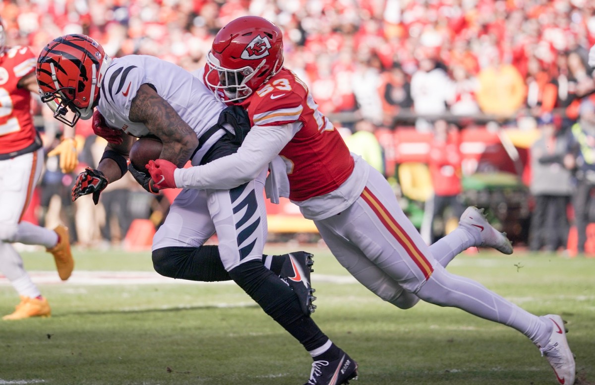 Jan 30, 2022; Kansas City, Missouri, USA; Cincinnati Bengals wide receiver Ja'Marr Chase (1) catches a pass and is tackled by Kansas City Chiefs middle linebacker Anthony Hitchens (53) during the AFC Championship game at GEHA Field at Arrowhead Stadium. Mandatory Credit: Denny Medley-USA TODAY Sports