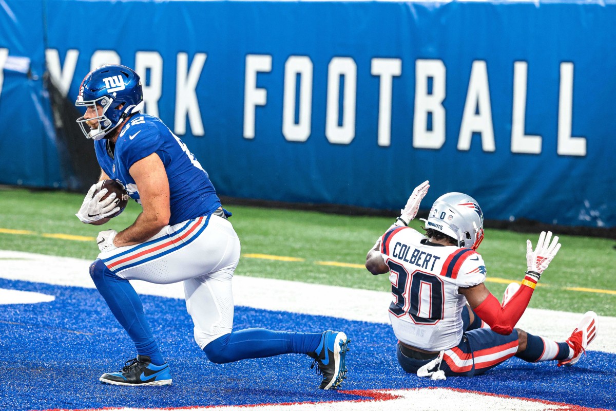 Aug 29, 2021; East Rutherford, New Jersey, USA; New York Giants tight end Kaden Smith (82) reacts after scoring on a touchdown reception against New England Patriots free safety Adrian Colbert (30) during the first half at MetLife Stadium. Mandatory Credit: Vincent Carchietta-USA TODAY Sports