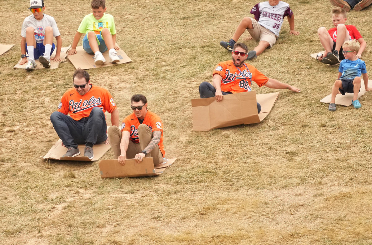 Orioles players sled down the hill overlooking Lamade Stadium at the Little League World Series Complex in South Williamsport, Pennsylvania.