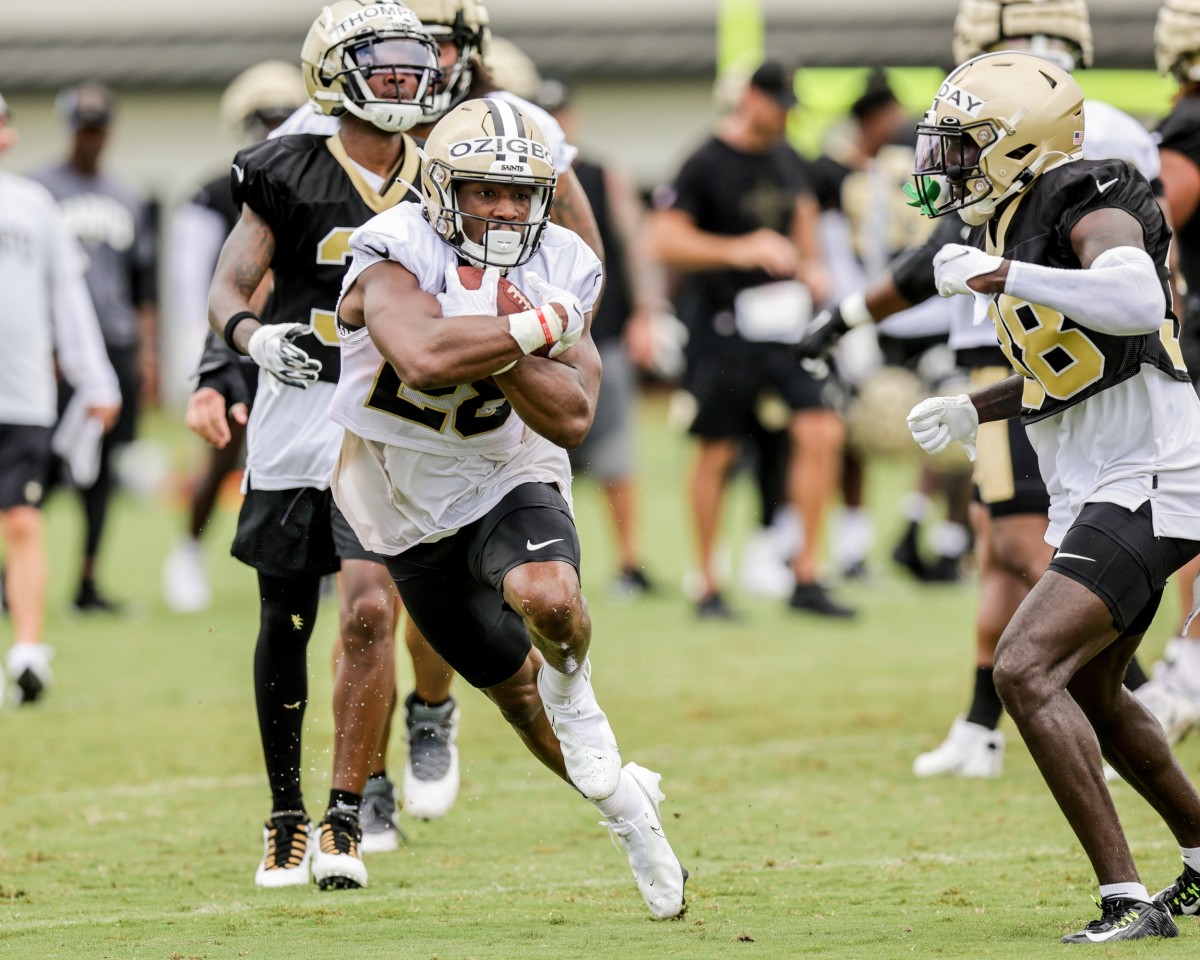 Jul 29, 2022; New Orleans Saints running back Devine Ozigbo (28) runs from safety Smoke Monday (38) during training camp. Mandatory Credit: Stephen Lew-USA TODAY