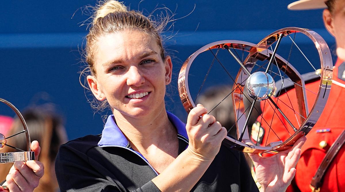 Aug 14, 2022; Toronto, ON, Canada; Simona Halep (ROU) poses with the National Bank Open trophy after defeating Beatriz Haddad Maia (not pictured) in the women’s final of the National Bank Open at Sobeys Stadium.