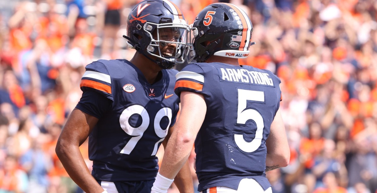 Virginia Cavaliers wide receiver Keytaon Thompson and quarterback Brennan Armstrong celebrate after scoring a touchdown against Illinois.
