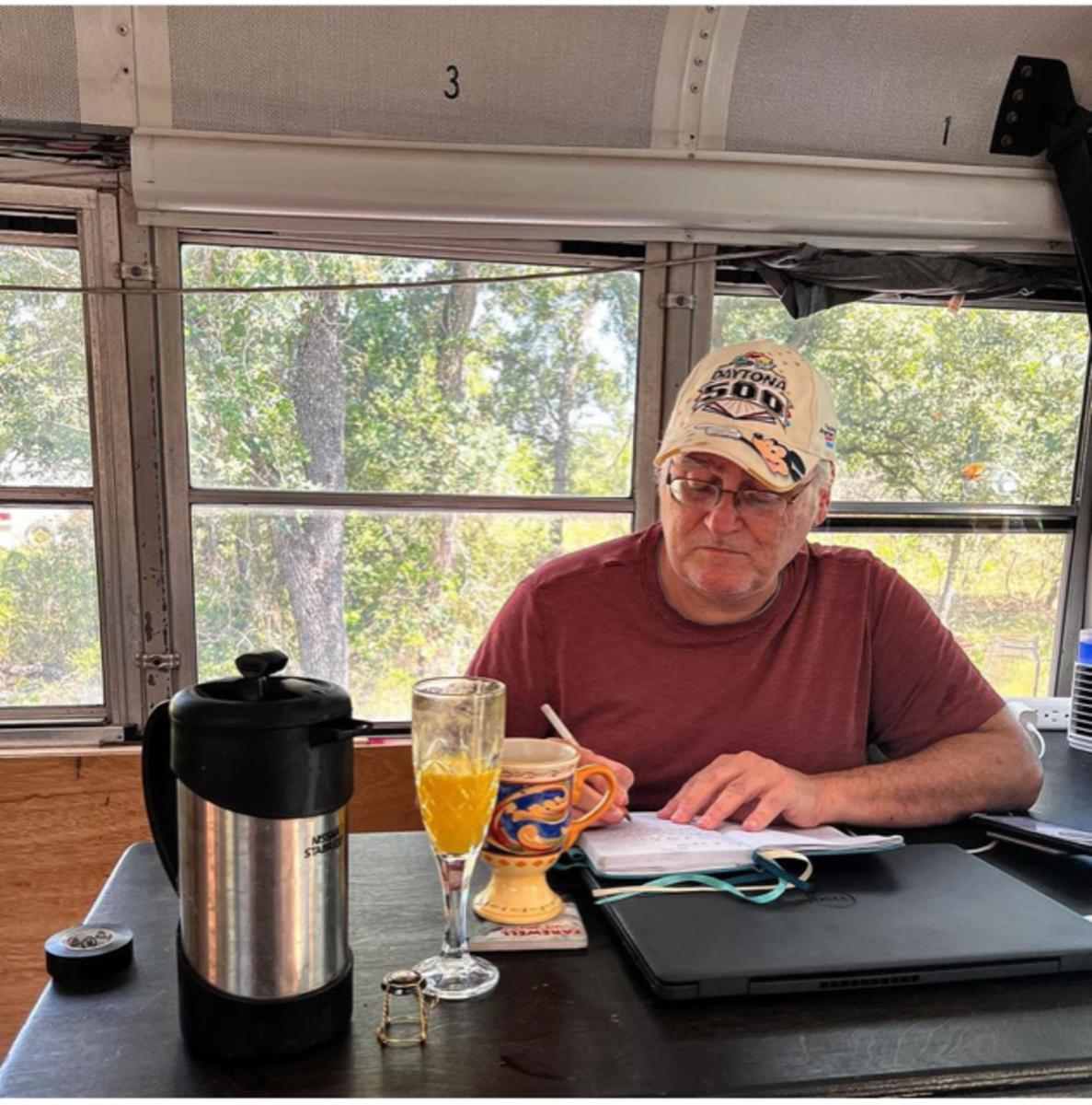 Dan Beaver, who along with daughter Victoria has done all the work in converting the former school bus into a rolling writer's retreat, is already mapping out the Lap Around America project before it hits the road in January. Photo courtesy: Dan Beaver.