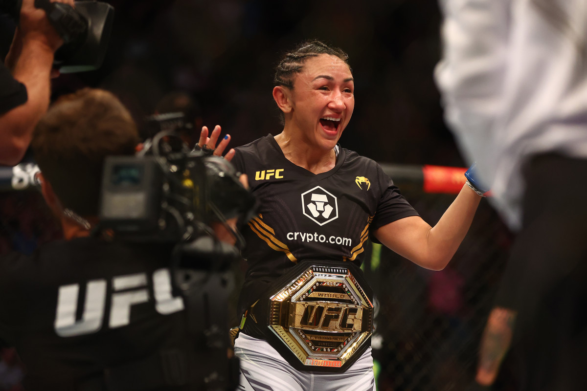 Carla Esparza reacts to her championship victory against Rose Namajunas during UFC 274 at Footprint Center.