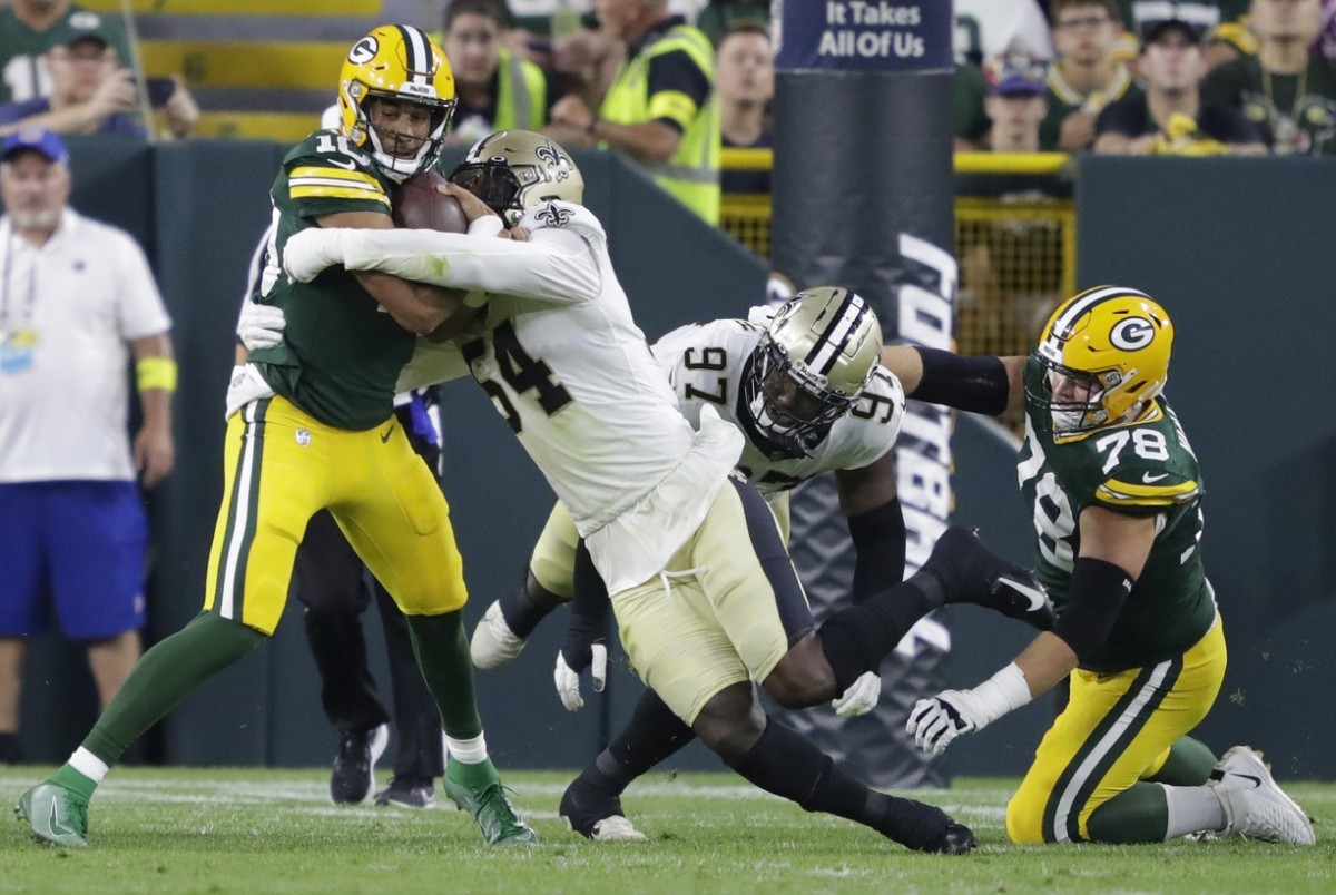 Green Bay Packers quarterback Jordan Love (10) is tackled by New Orleans Saints defensive end Taco Charlton (54). Mandatory Credit: Dan Powers-USA TODAY NETWORK